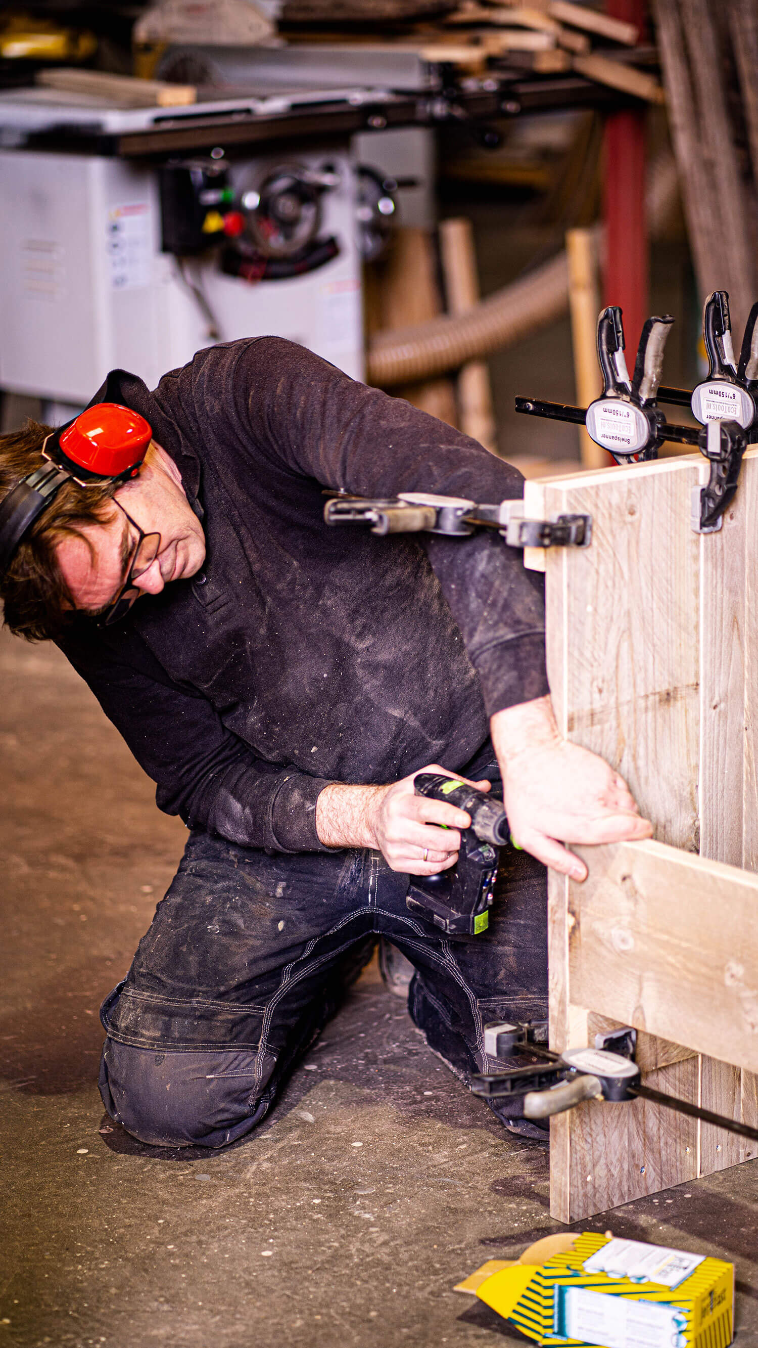 Kees Verkerke aan het werk met houten meubels in de Showroom in Sint-Maartensdijk